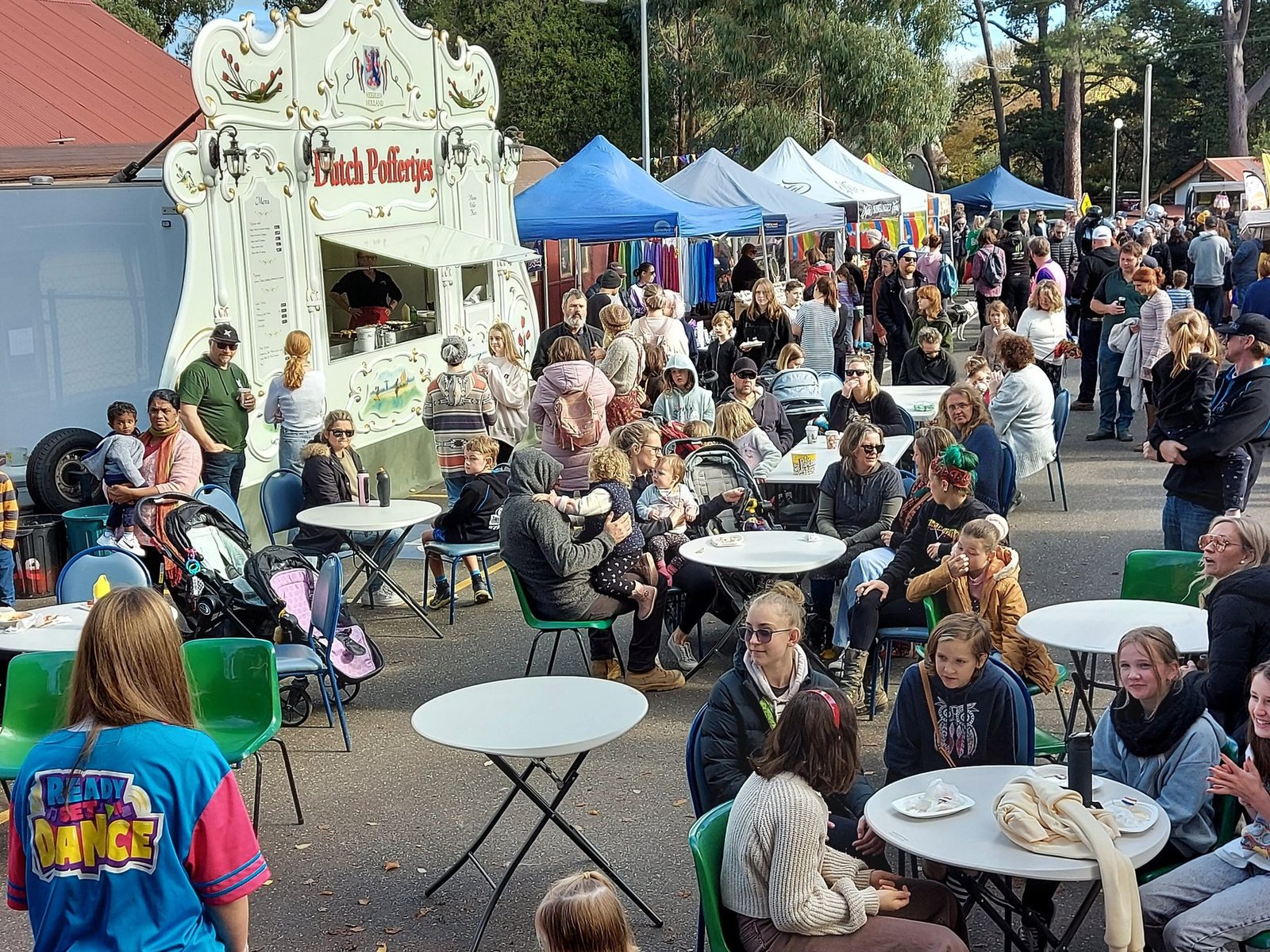 Crowds, stalls, food and festival activity at PAVED Festival
